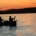 Silhouette of paddlers in a canoe at sunset