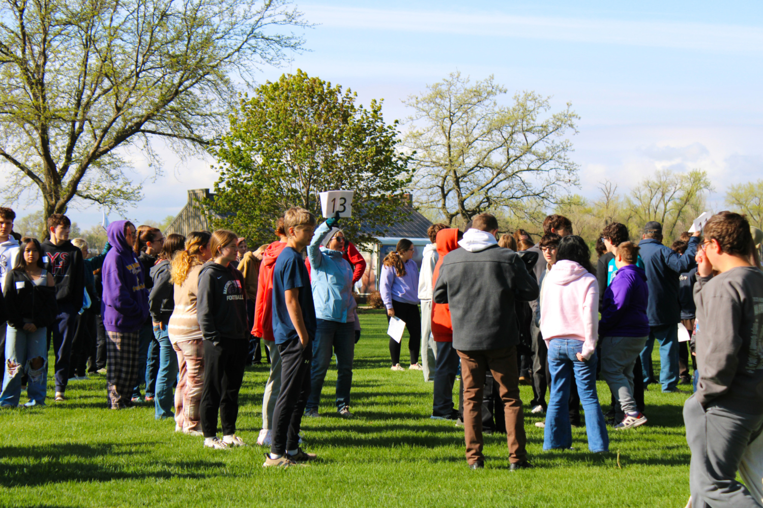 Students gather into groups led by volunteers.