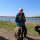 A young boy sits, balancing on a tire